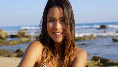 Beautiful young brunette woman at the beach