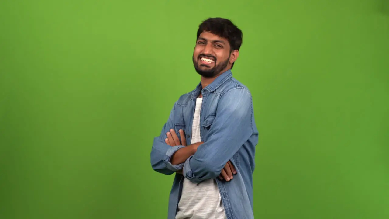 Rejoicing Asian male showing off his happiness and rejoicing over his success in a green screen shoot