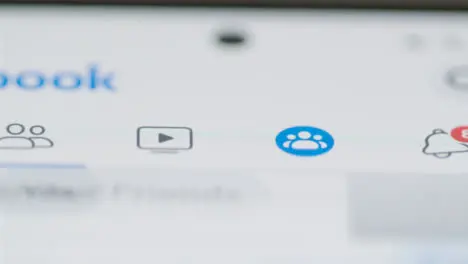 Tracking Close Up of a Finger Pushing Facebook Group Button on Phone