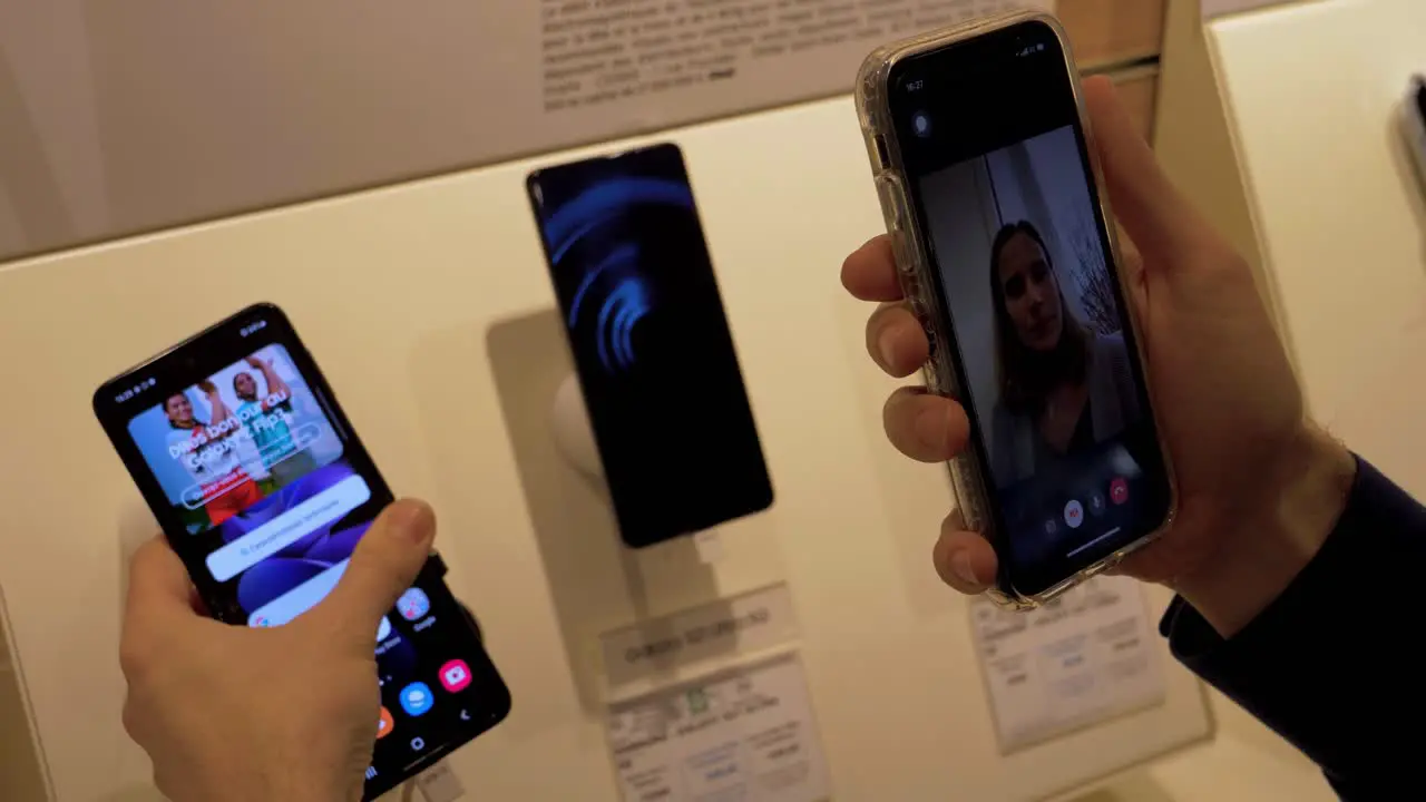 Man calling his wife to show the new smartphone from Samsung that can fold and is touch screen