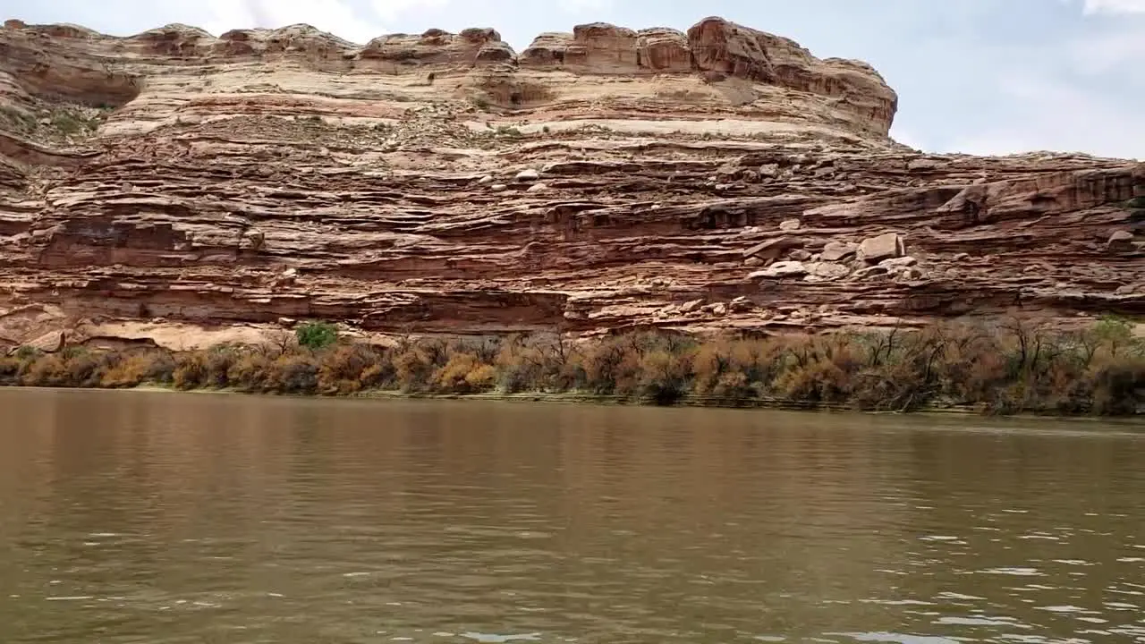 Pan of canyon wall from river in Utah