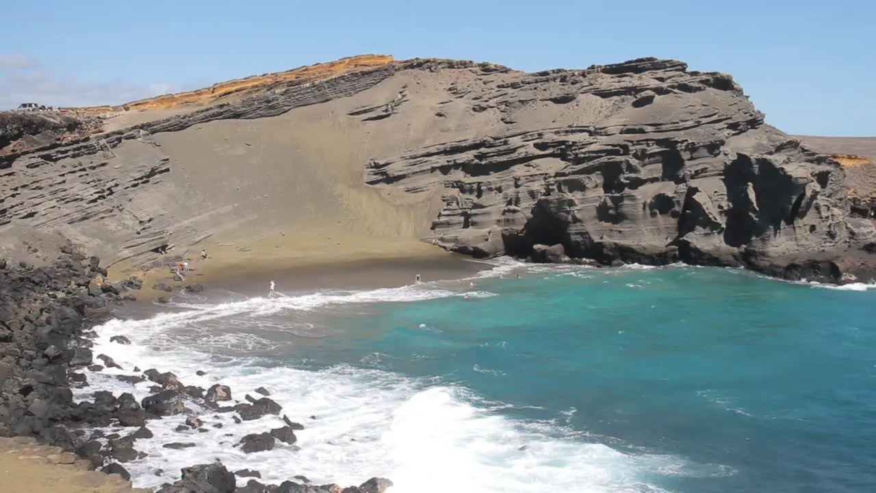 Waves Crash Against Shore on Green Sand Beach in Hawaii