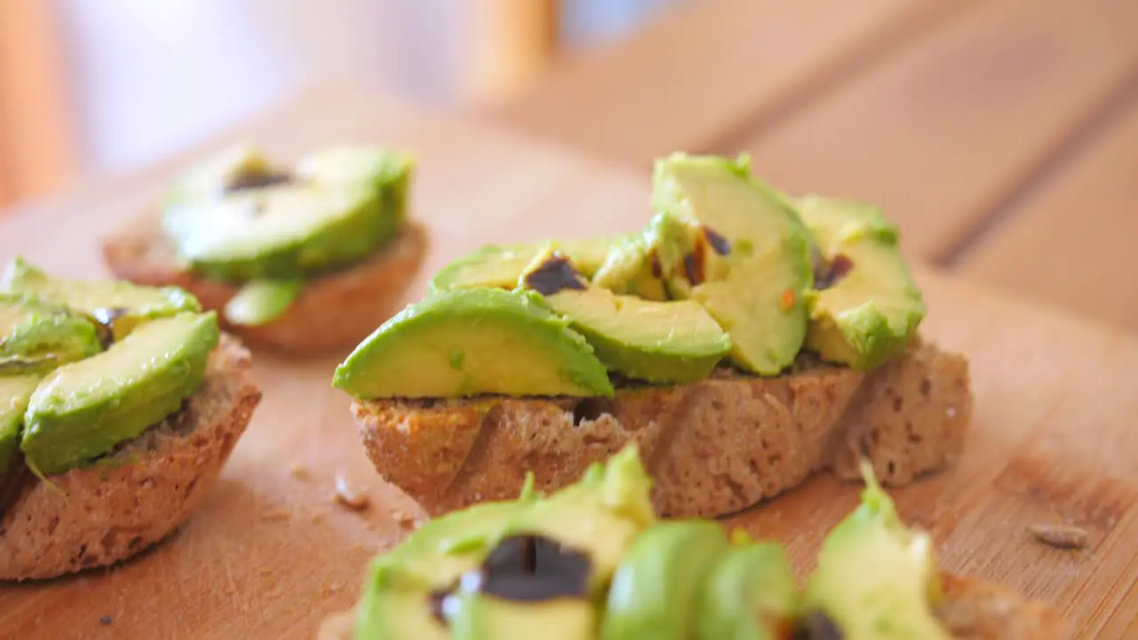 Close up view of breakfast sandwich of homemade bread with sliced Avocado