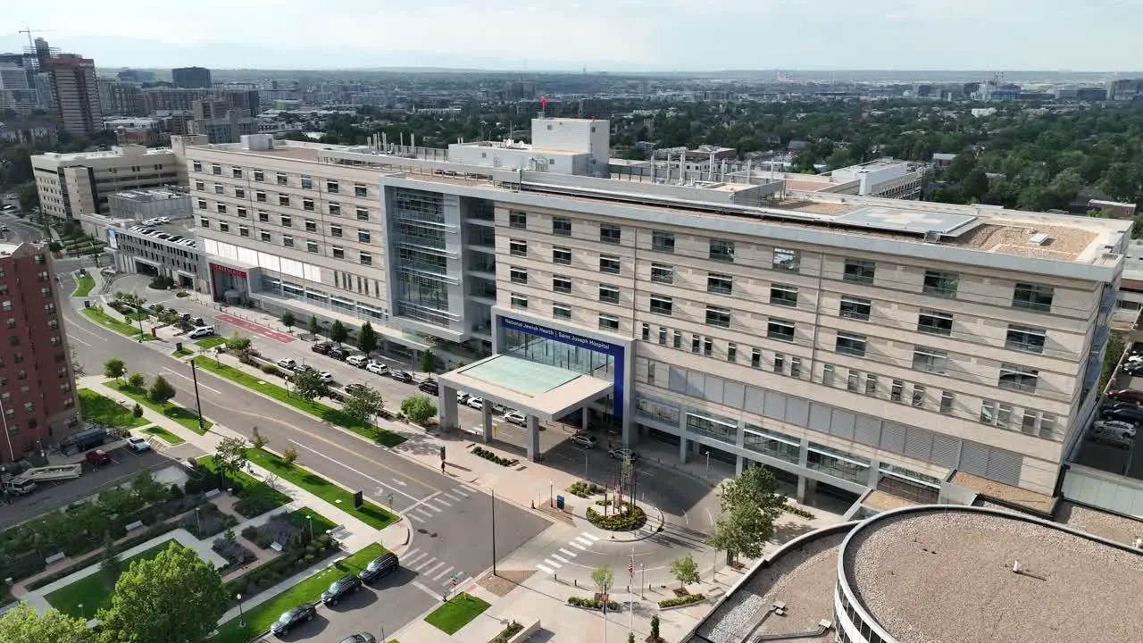 Aerial pullback riser from Saint Joseph Hospital reveals Denver city skyline