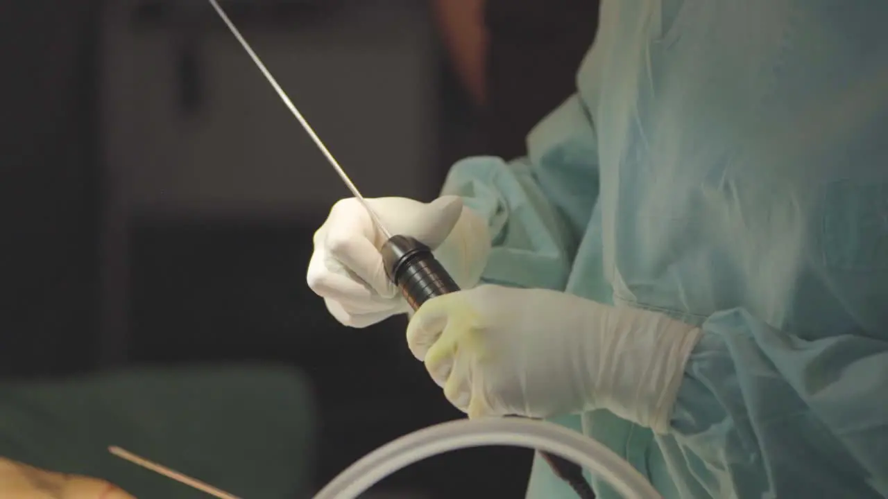 Plastic surgeon manipulating a suction catheter for fat removal on argentina