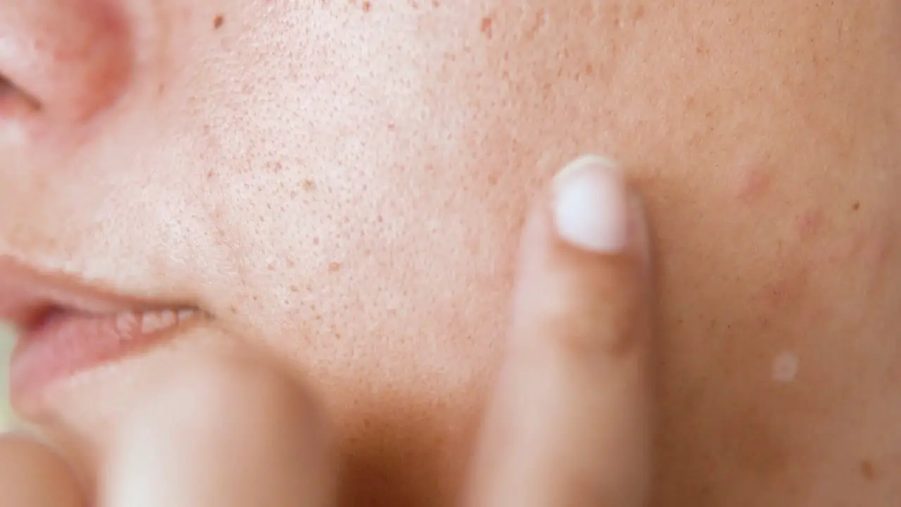 Face Mole scrutinise with hand close up 4K shot