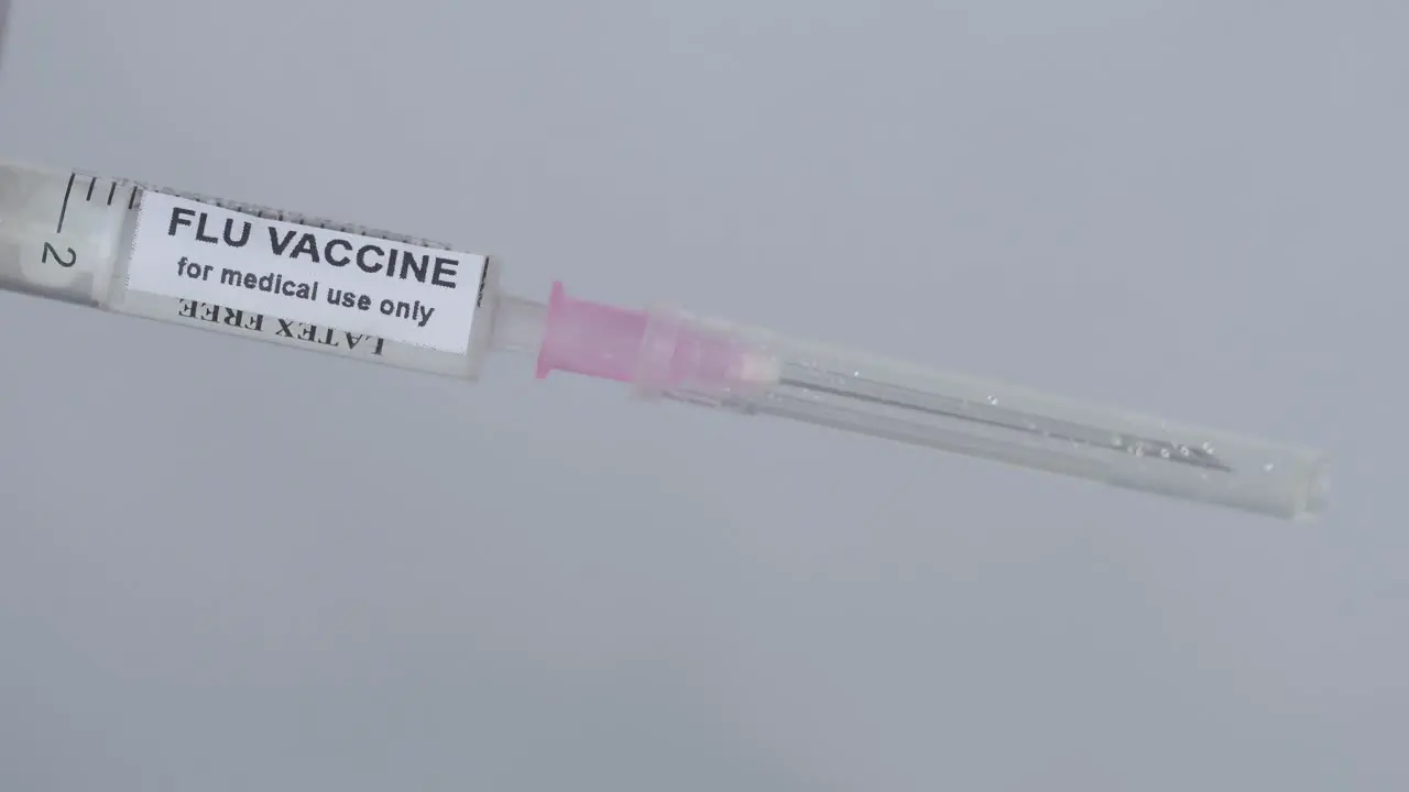 Doctor's Hand Attaching Needle To Syringe Flu Vaccine close up