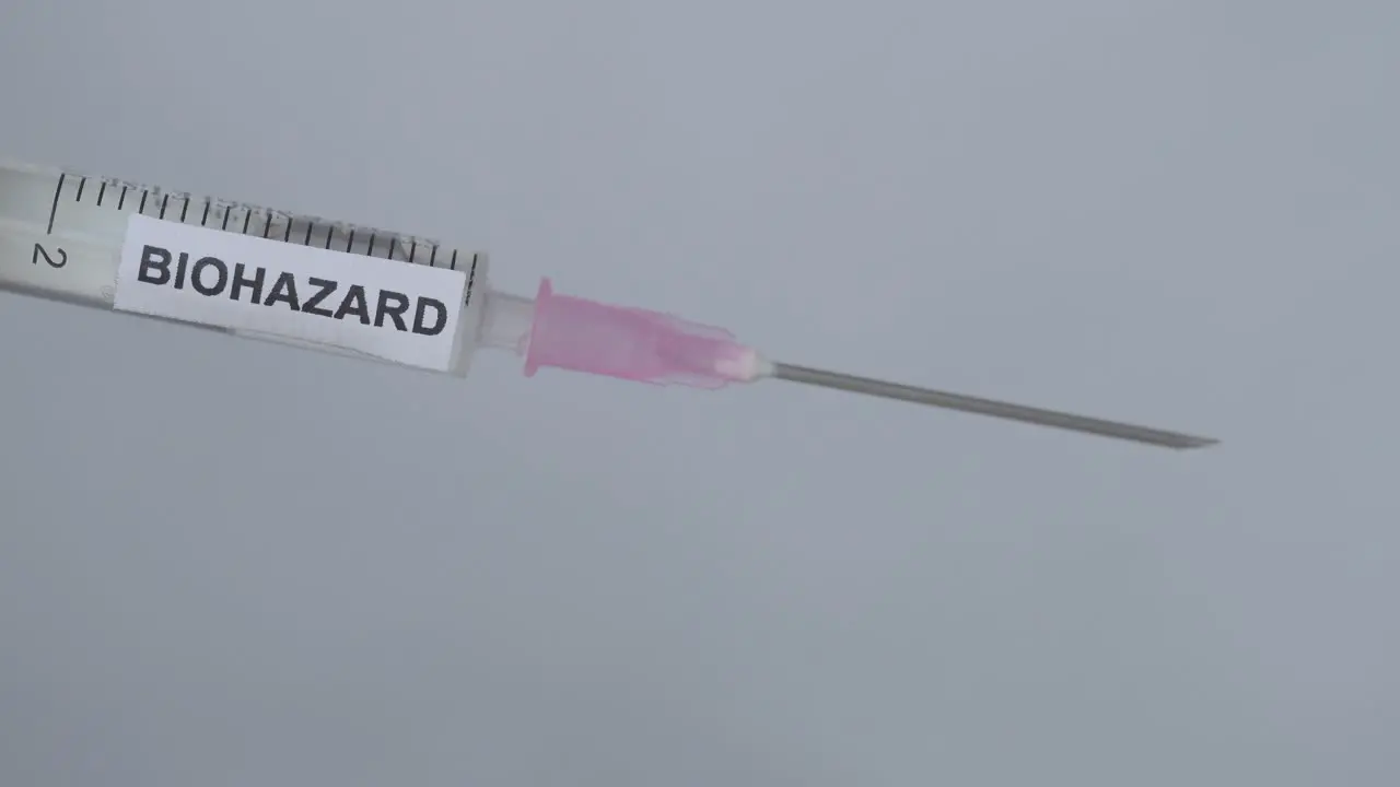 Coronavirus Vaccine In A Biohazard Syringe Medical Concept 2020 close up