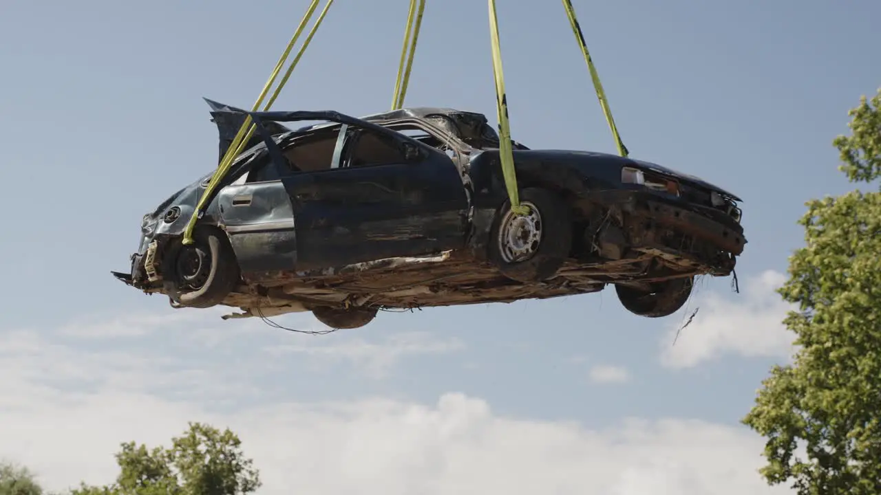 Poor man's car destroyed in a freak accident hanging at a junkyard