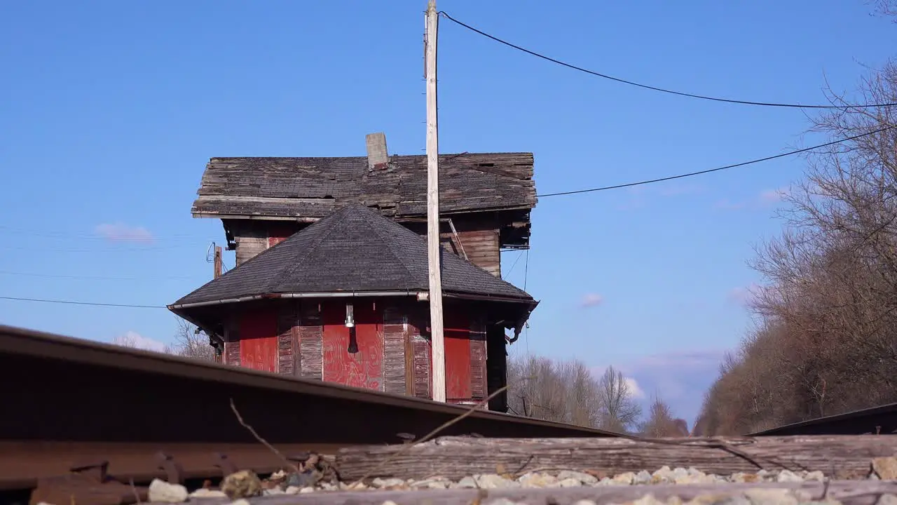 An old abandoned railways station platform and empty rail line railroad track in distance suggests lonely places 1