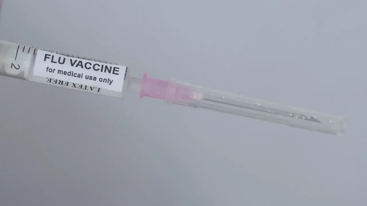 Hand Removes Cap Of Flu Vaccine Syringe Medical Concept close up