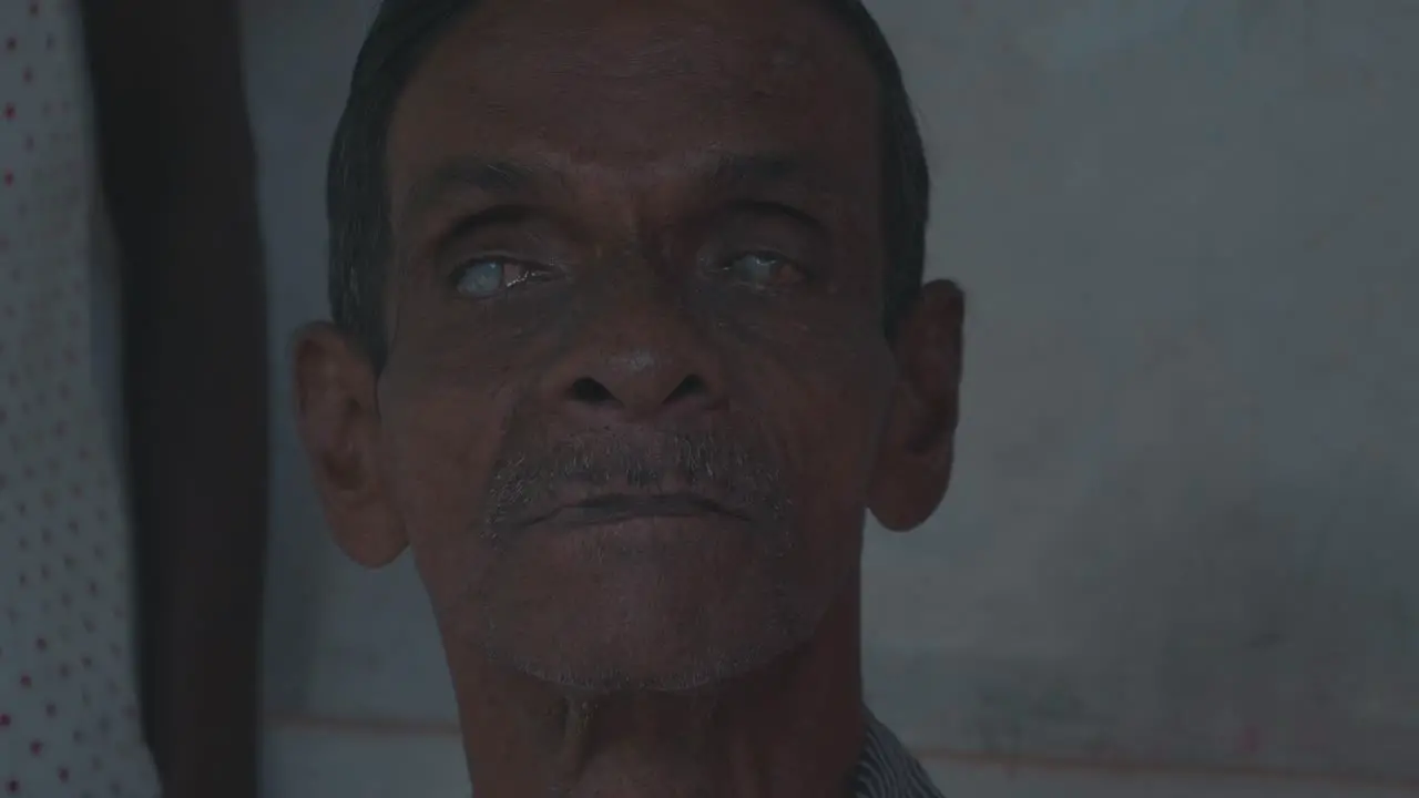 a blind and disabled old man looking straight into the camera in sri lanka symbolizing the bad medical supply situation in developing countries