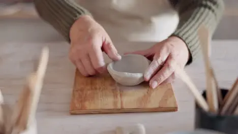 Clay bowl woman hands and sculpture in artist