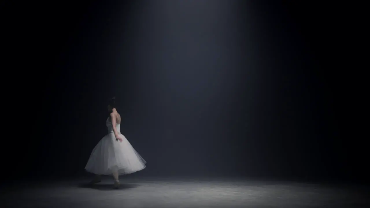 Gorgeous woman soaring in ballet dress on stage Ballerina dancing indoors