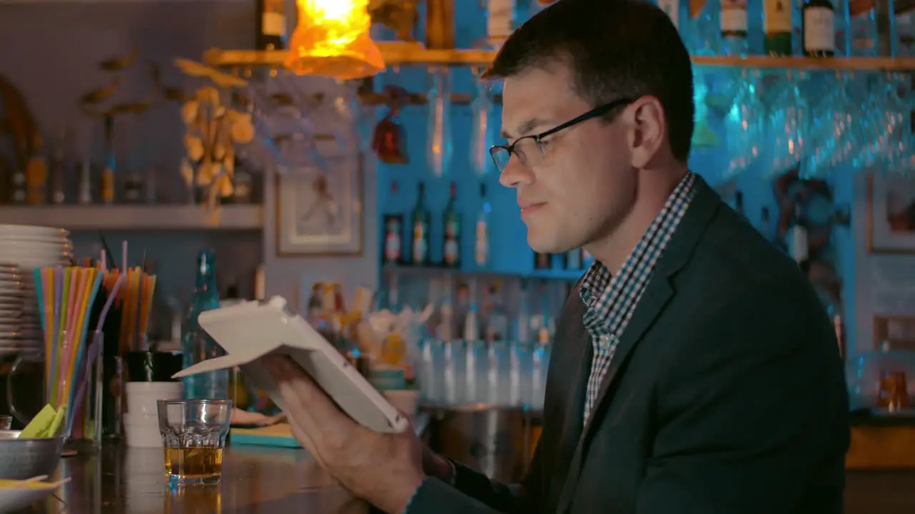 Businessman with Tablet in the Bar