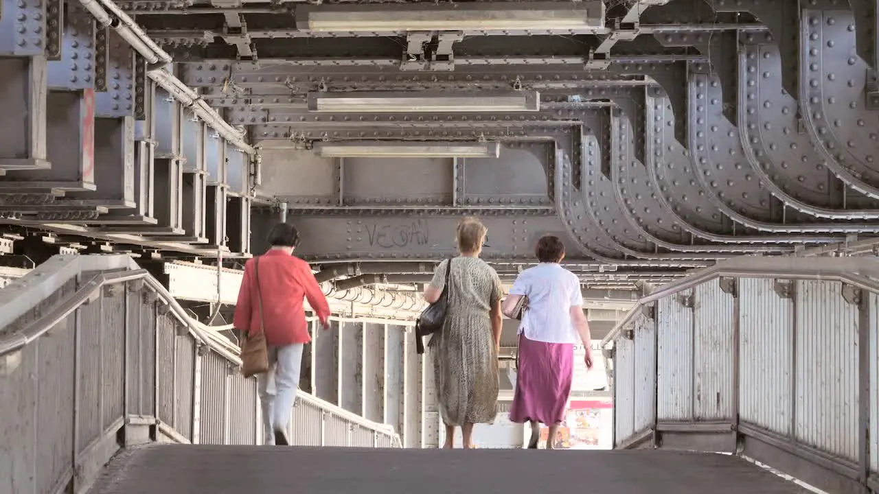 Group of Ladies Walking Under Bridge