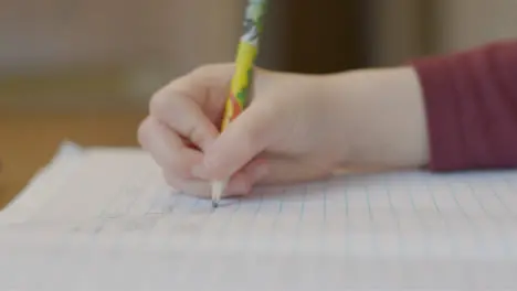 Close Up Shot of Childs Hand As They Write On Piece of Paper