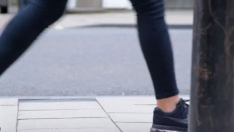 Medium Shot of Pavement as Persons Feet Walk Along It