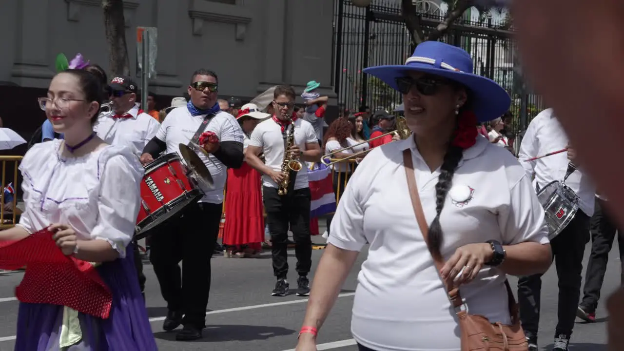 Dancers and Marching Band Walking Down Avenue During Costa Rican Independence Day Parade