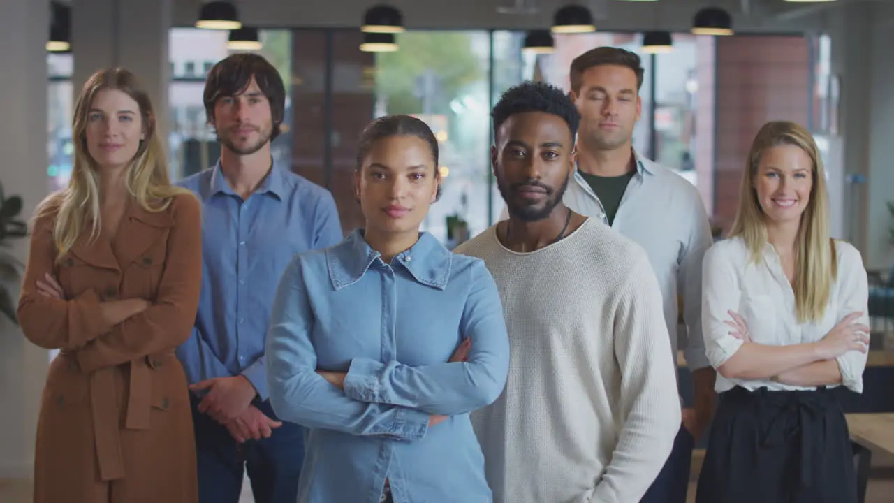 Portrait Of Multi-Cultural Business Team Standing In Modern Open Plan Office