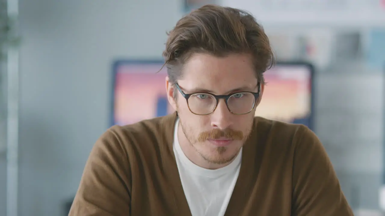 Portrait Of Smiling Male Architect In Office Working At Desk