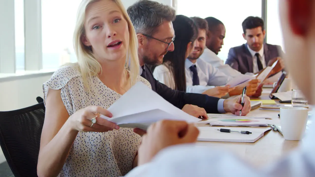 Group Of Businesspeople Meeting Around Table In Boardroom