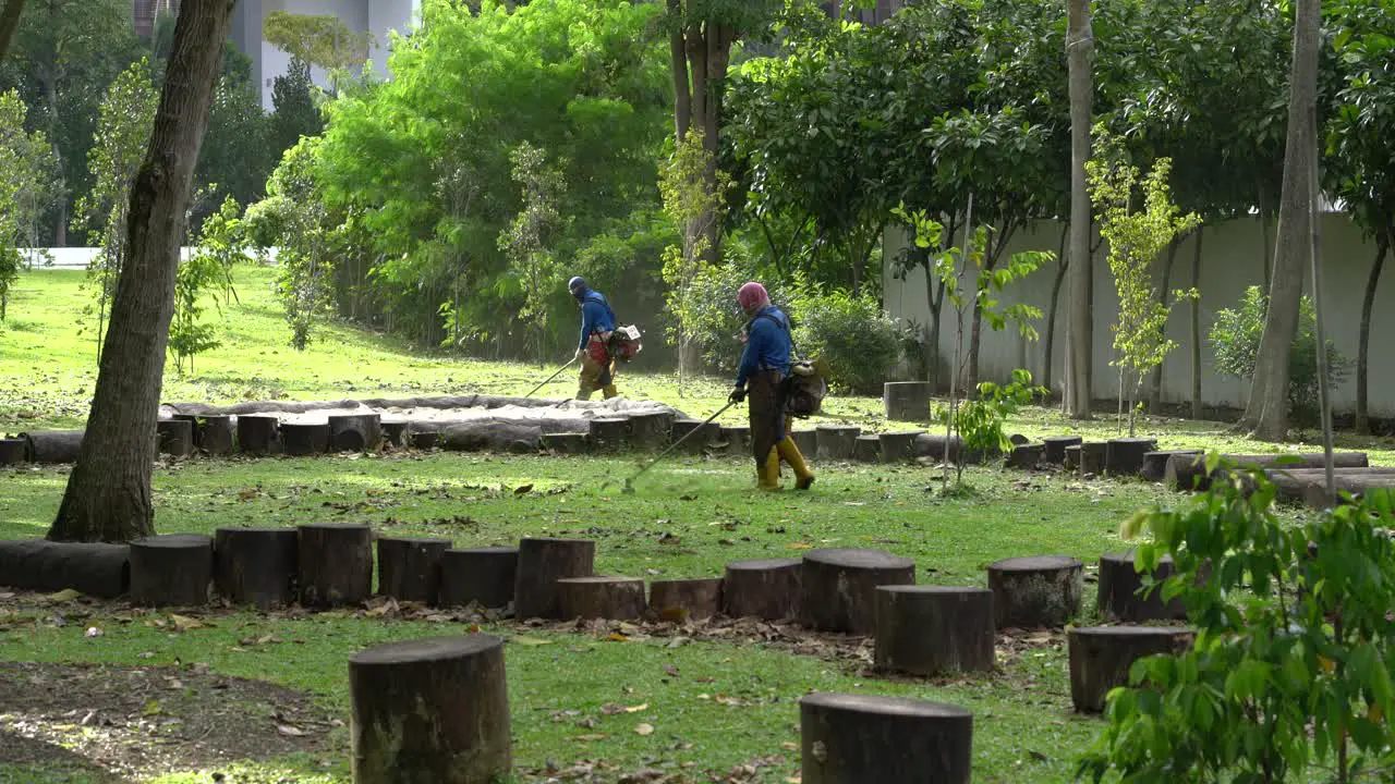 Workers cutting grass at Kim Seng Park Roberson Quay  Singapore