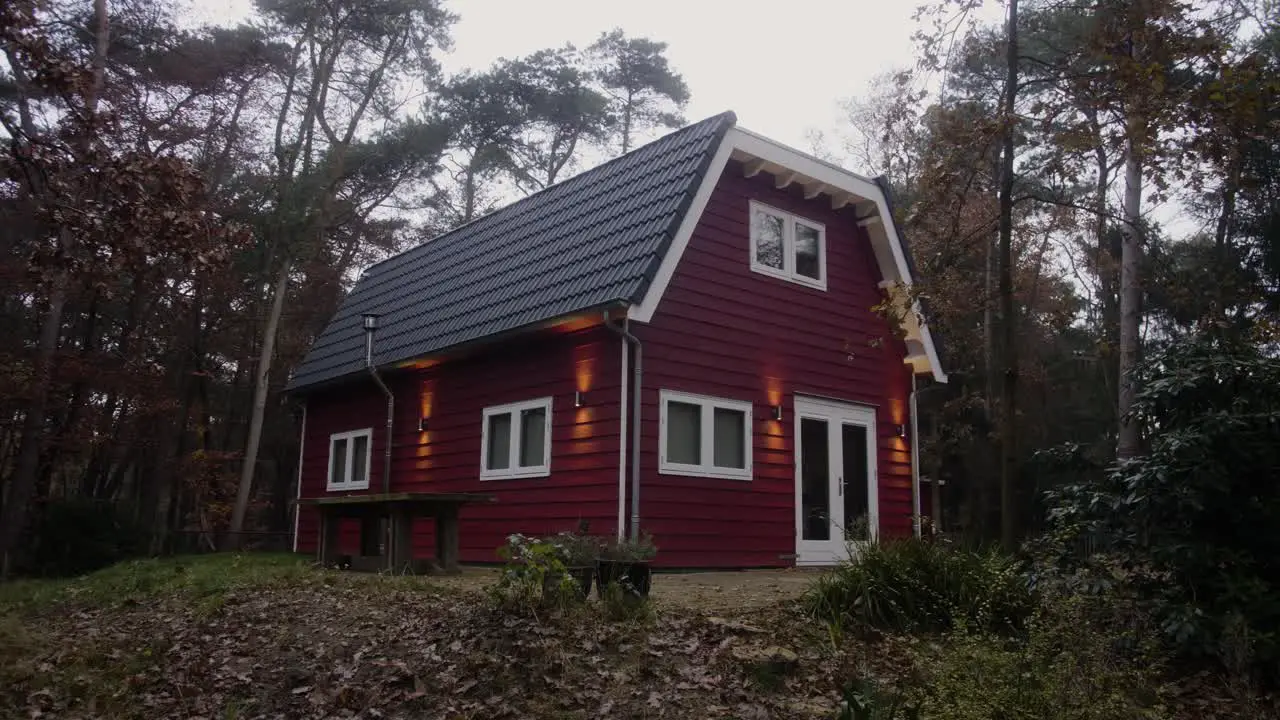 Red wooden house in the forest during winter