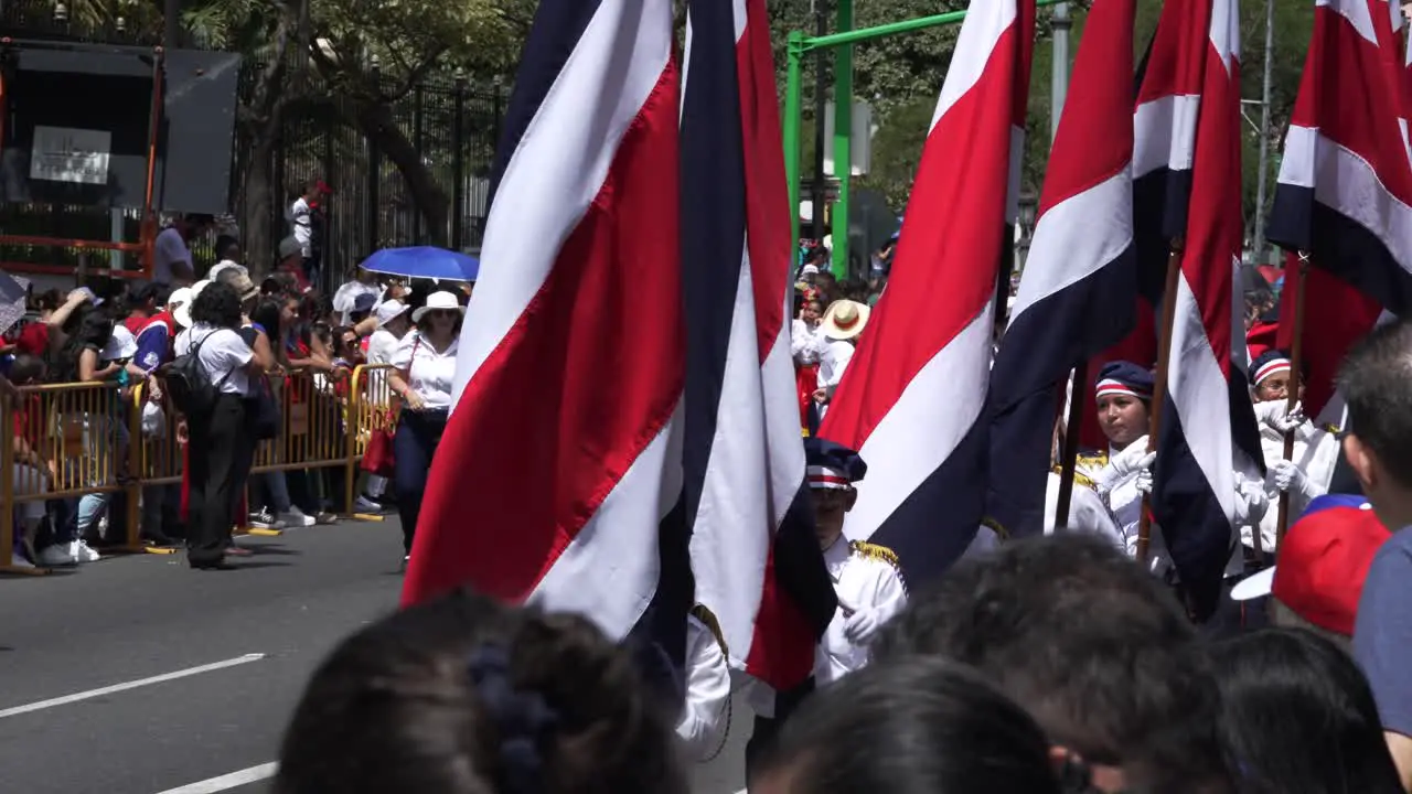 Flag Bearers Marching Down Avenue During Costa Rican Independence Day Parade