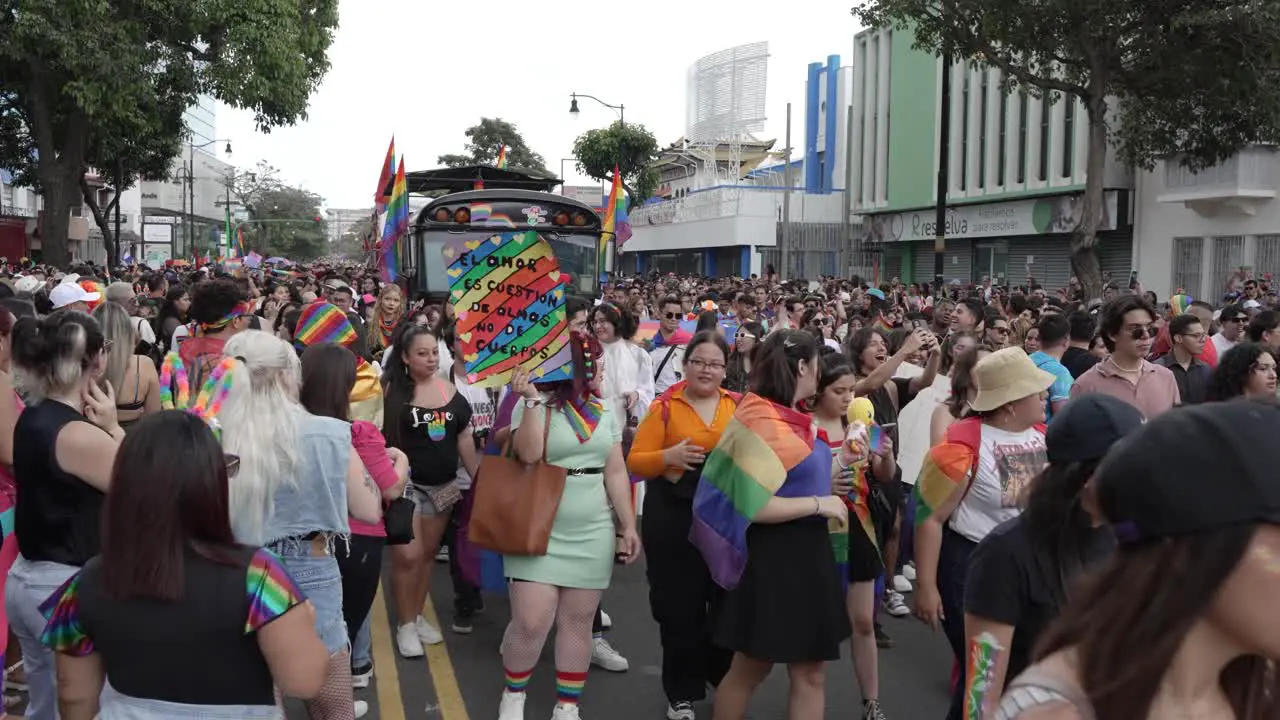 People Marching During Pride Parade with Flags and Signs