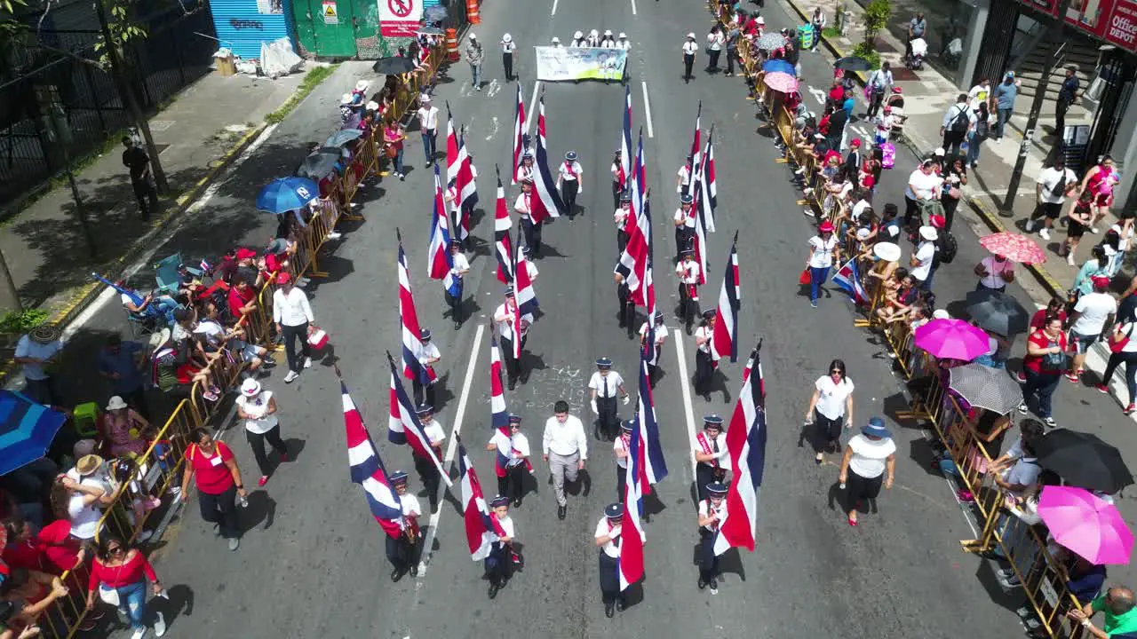 Drone Shot Over Flag Bearers Marching During Costa Rican Independence Day Parade in San Jose