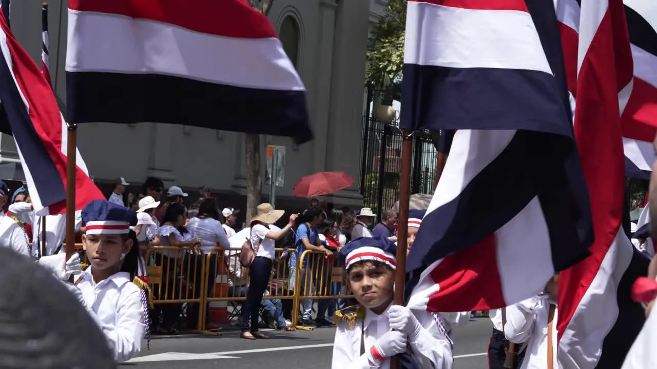 Student Flag Bearers Marching Down Avenue During Costa Rican Independence Day Parade