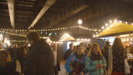 Busy Christmas Market Stalls On London South Bank At Night