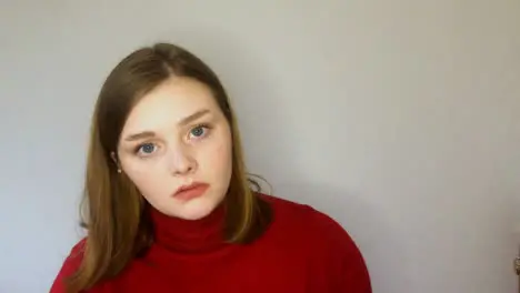 Female Young Student Listening Intently Whilst Looking Directly into Camera