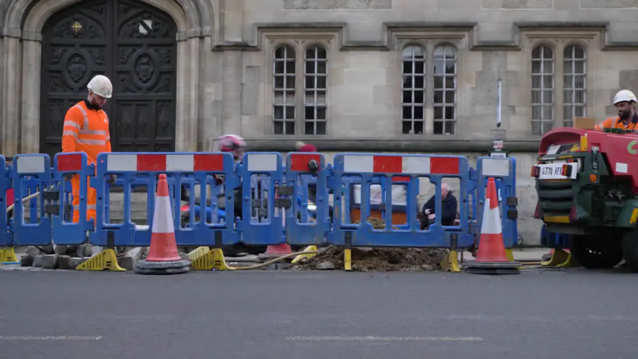 Wide Shot of Road Workers Working In Between Traffic In Oxford