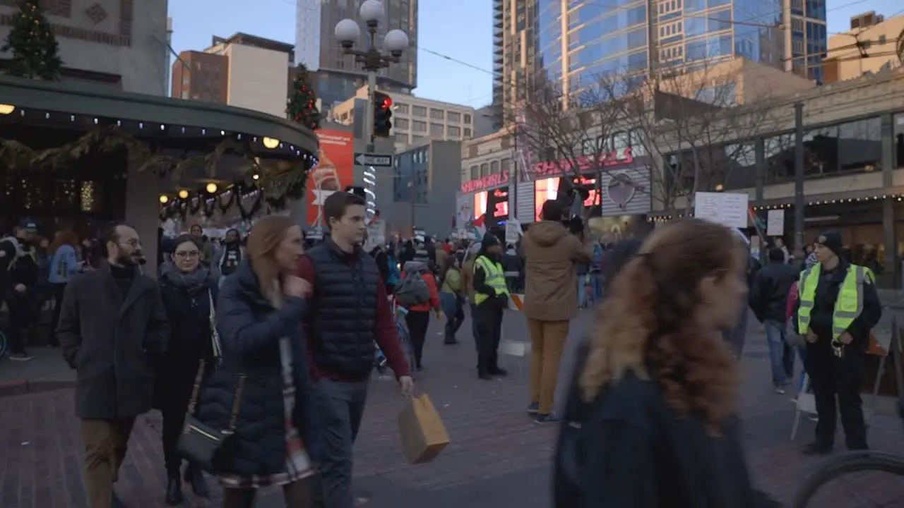 Protestors march while man speaks into megaphone