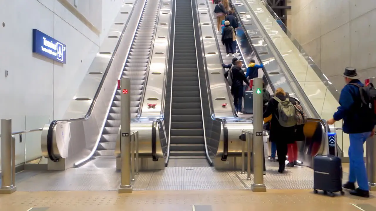 People on escalator in Helsinki-Vantaa Airport  Finland