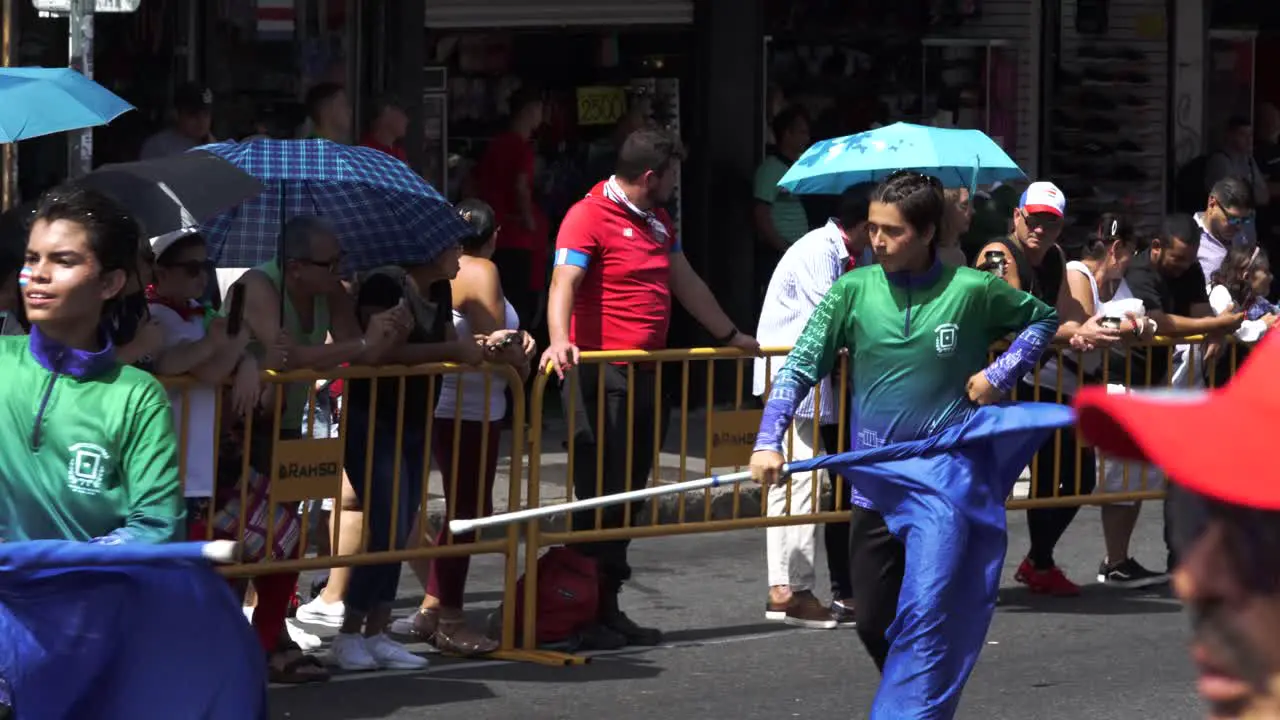 Young Male Students Waving Flags in Choreographed Dance During Costa Rican Independence Day Parade