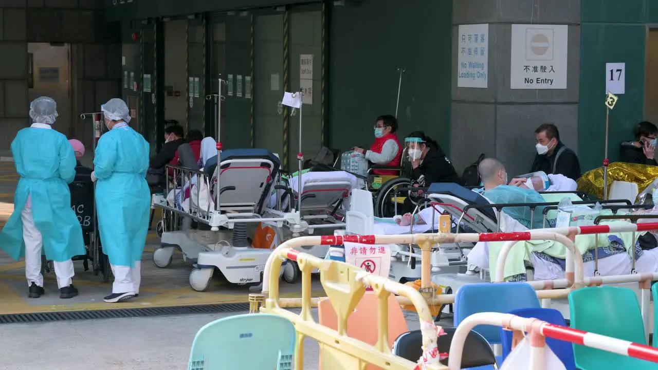 Medical staff attends to ill patients with Covid-19 symptoms as they lie on beds in the street outside an overcrowded hospital while the medical system collapses with hospitalizations