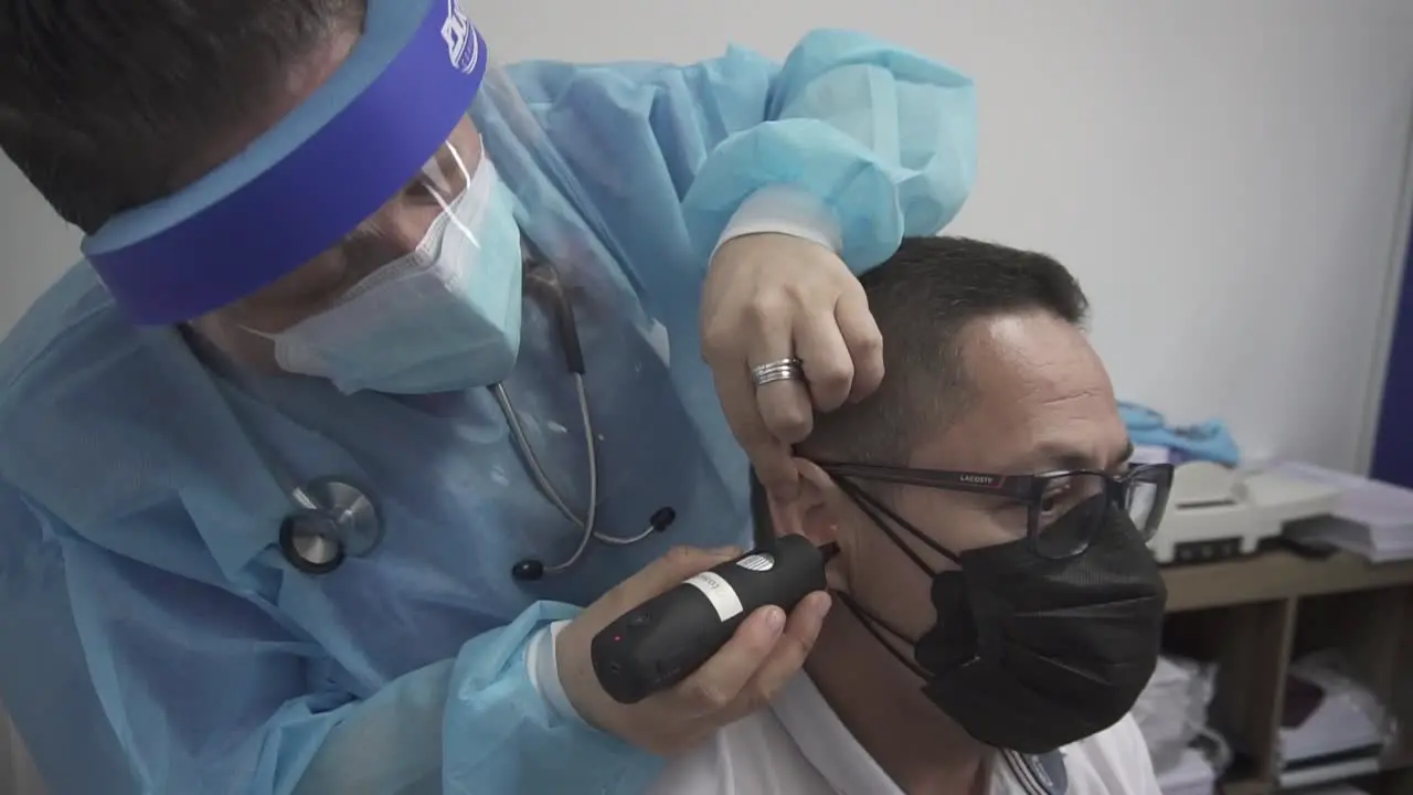 Doctor checks patient's ear consultation and medical care people in hospital with otorhinolaryngology specialist