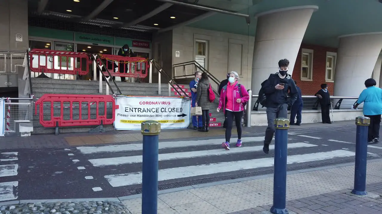 People wearing masks walk in and out of London Hospital in Pandemic