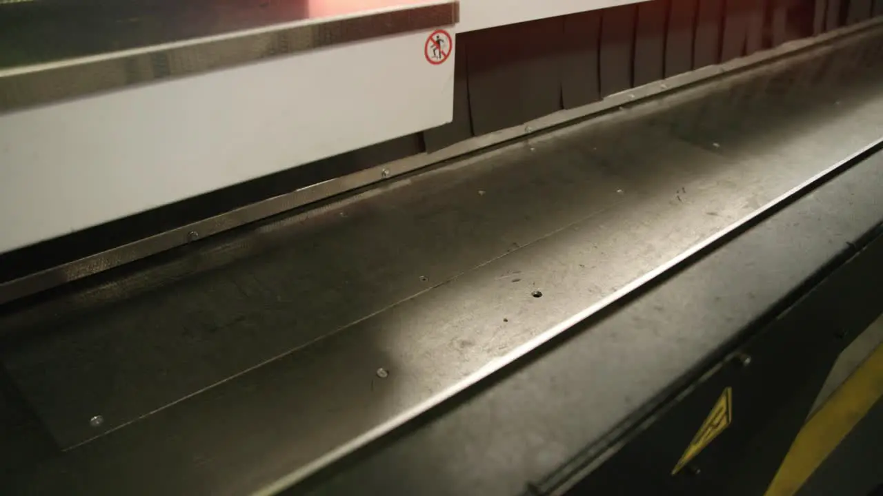 Footage of a finished piece of steel pipe falling out of the laser cutting machine