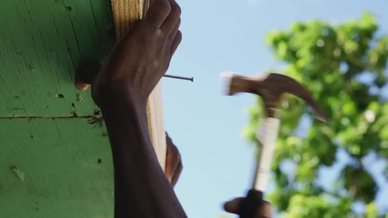 Carpenter working nailing wood with a hammer