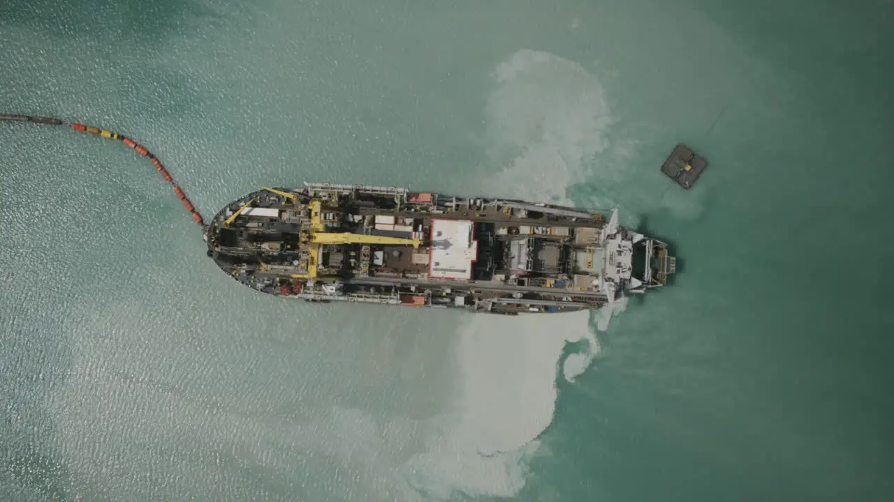 Tracked aerial hyperlapse of sand dredging ship in the Bari Italy harbor