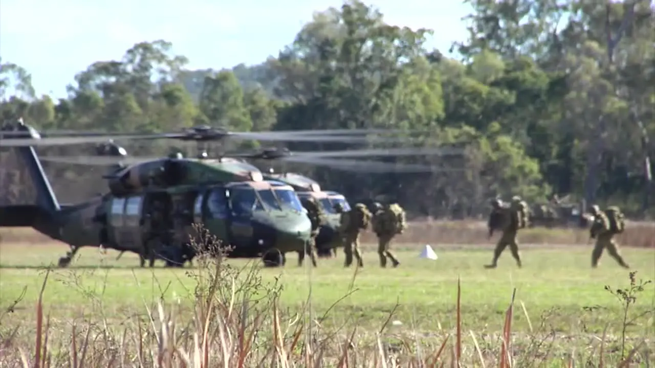 Australian Army Forces Load Into A Helicopter And Fly Away