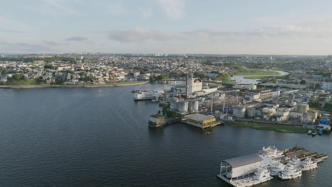 Aerial footage rotating around old refineries and factories in the sunrise light in Manaus Brazil