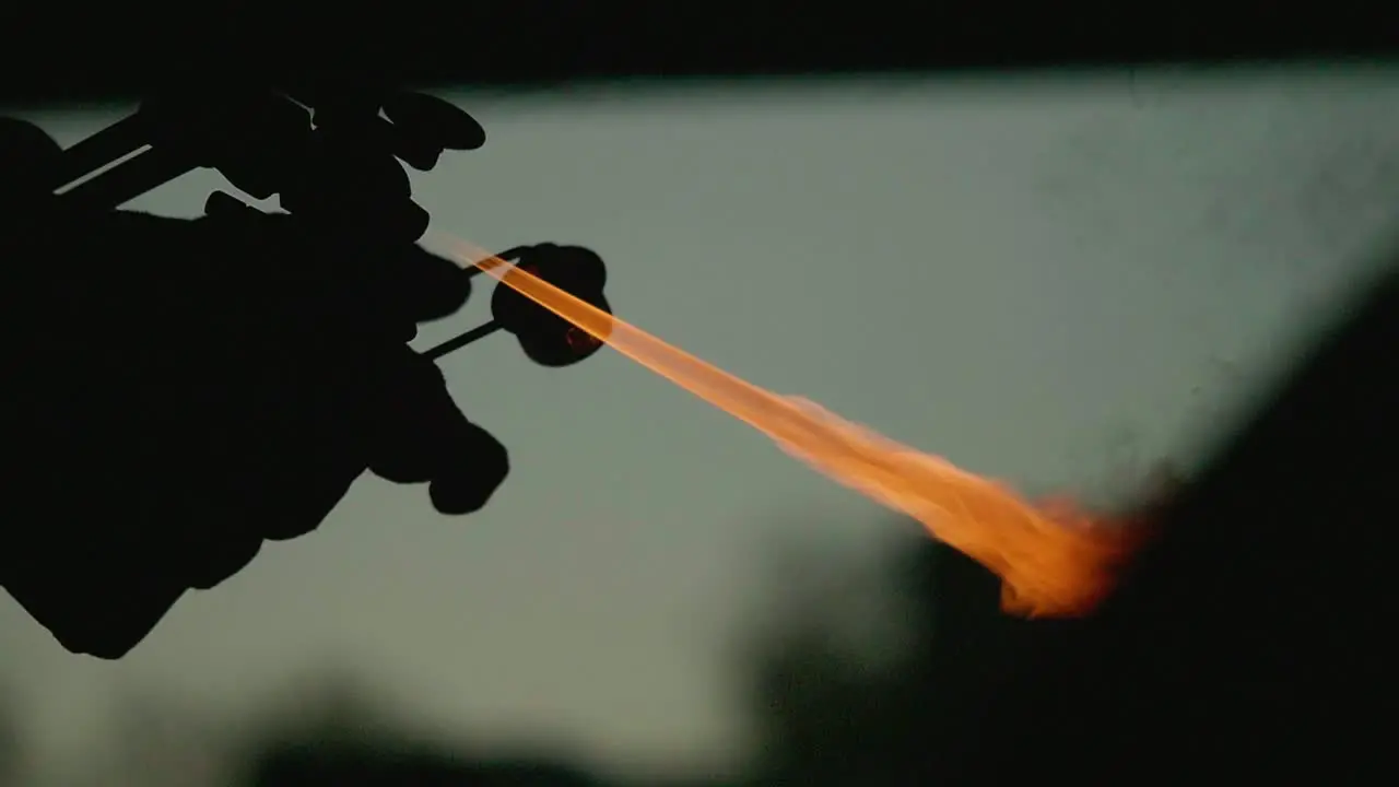 Igniting a flame cutter in slow motion silhouette