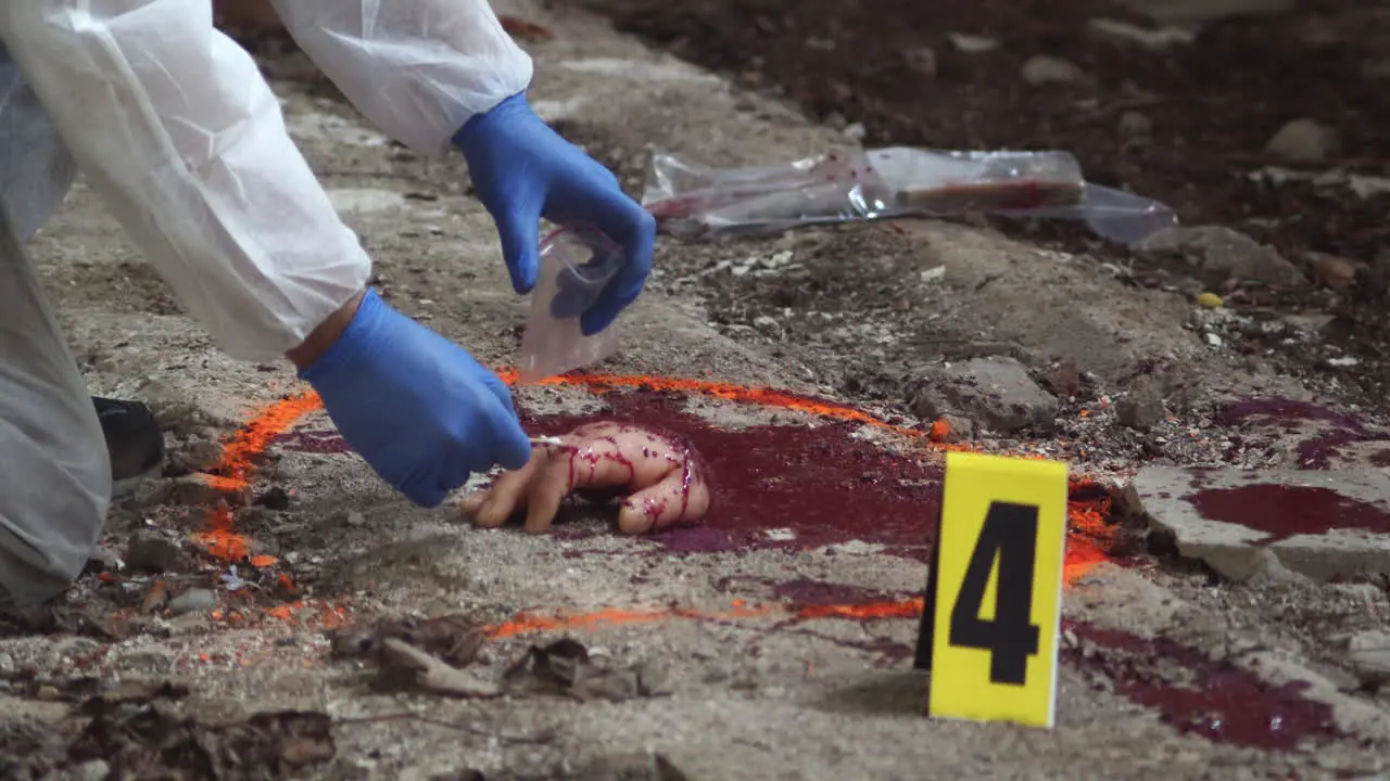 Forensic detective taking a blood or DNA sample from the scene of a horrific crime