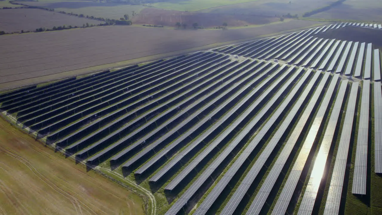 Aerial Birds Eye shot of Massive photovoltaic solar farm in rural area Production of renewable and green energy