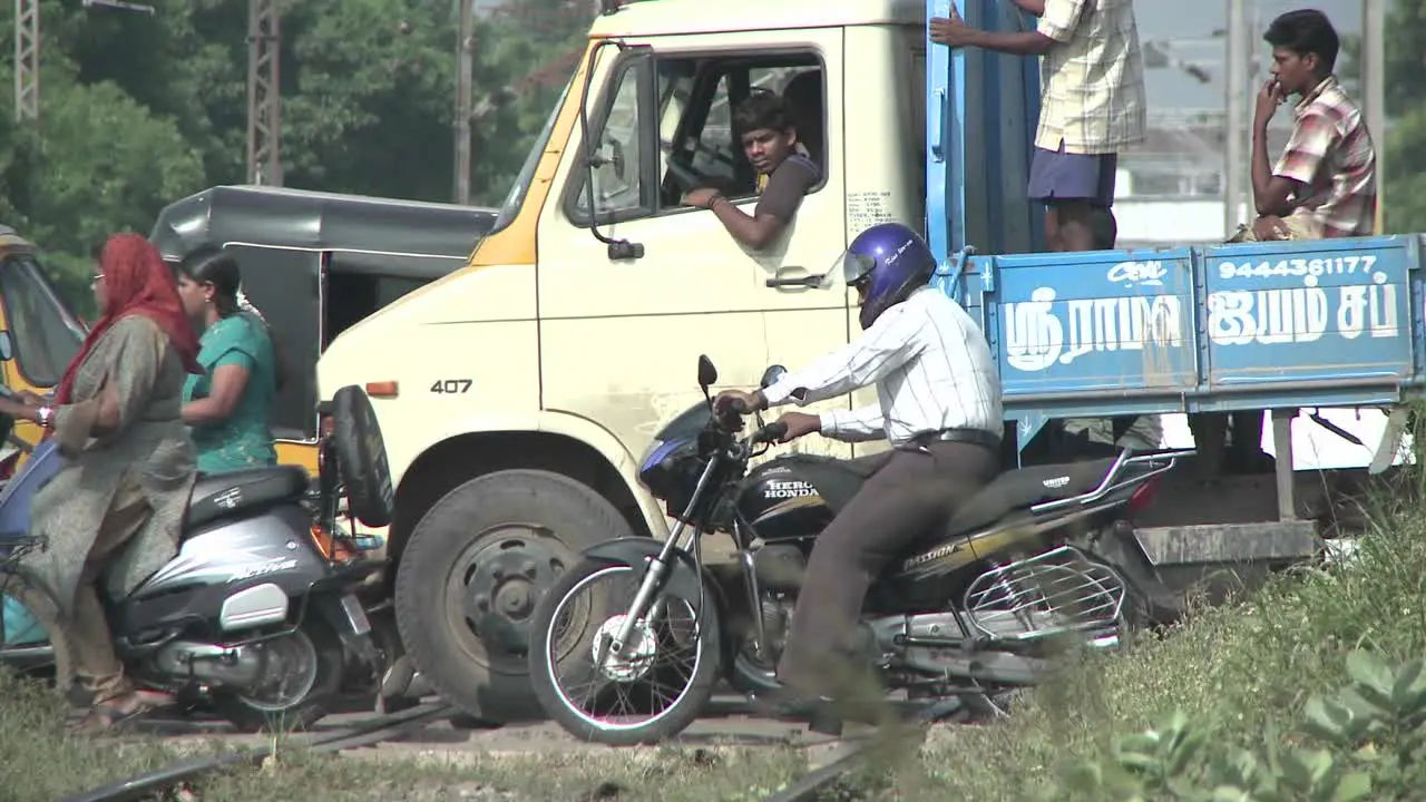 People and vehicles travel across traintracks